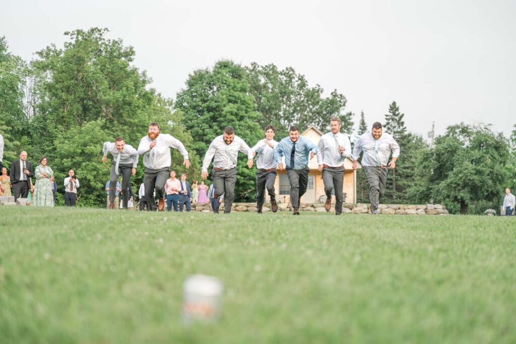 Groomsmen race adding a playful touch to the wedding celebration.