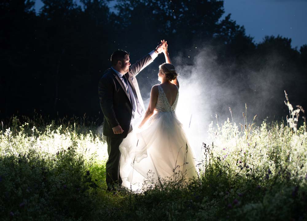 Bride and groom sharing a magical dance under the night sky at The Grove in Newport Maine.