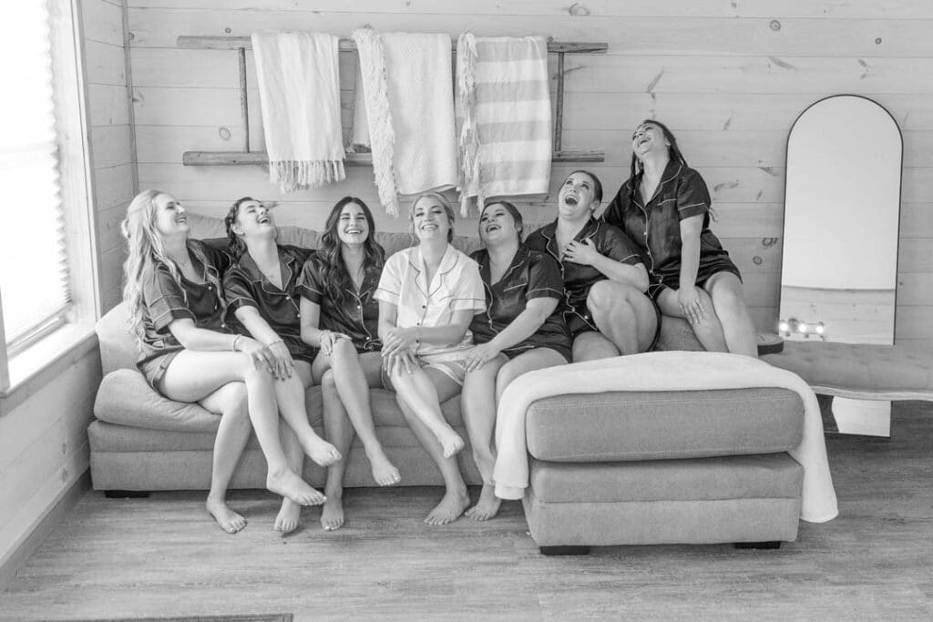 Bride and bridesmaids laughing and getting ready for the wedding
