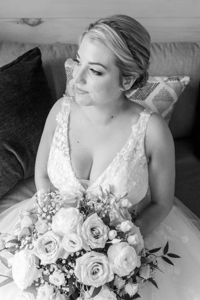 Bride holding a stunning bouquet in a serene outdoor portrait.